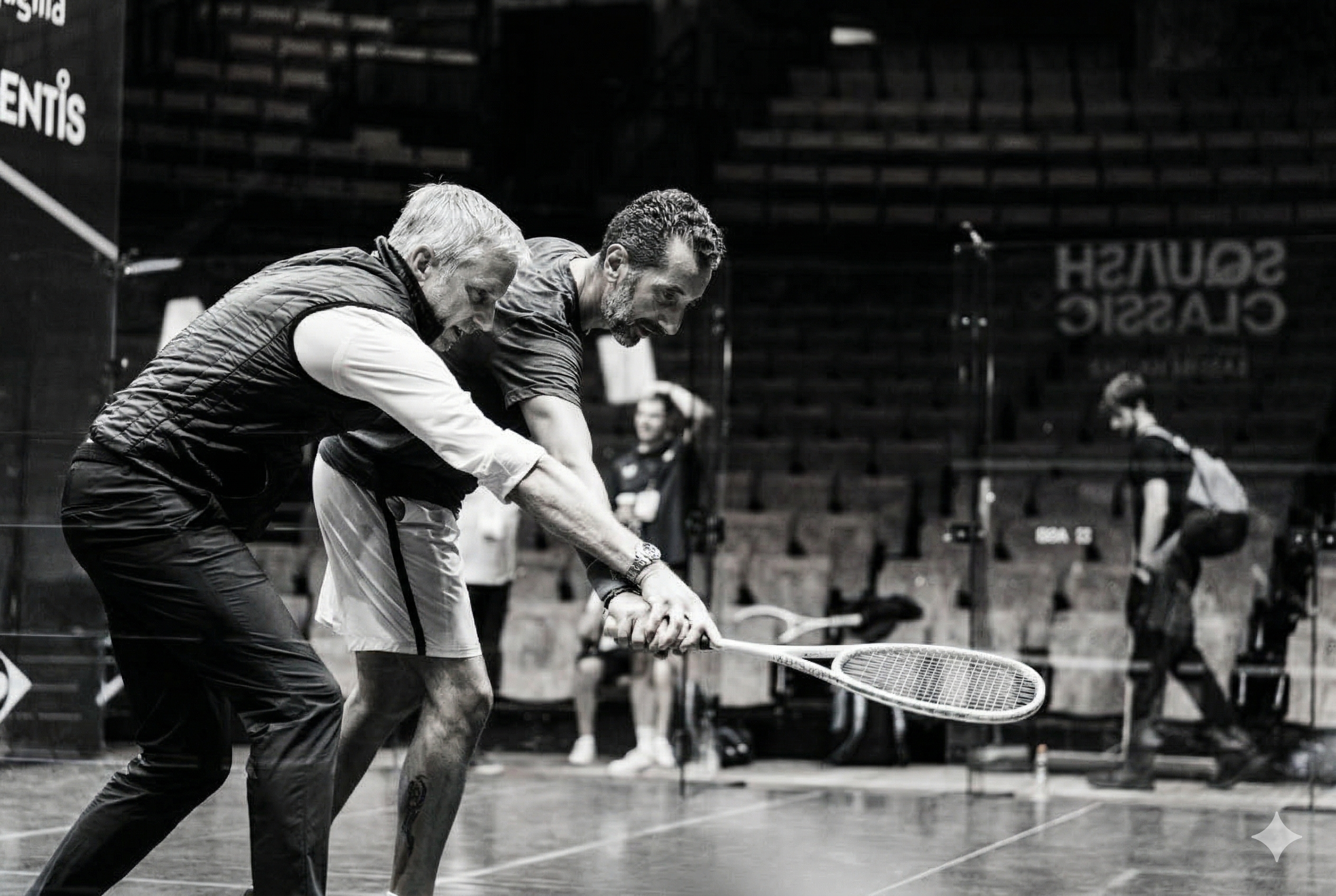 Squash coach guiding a player's backhand swing