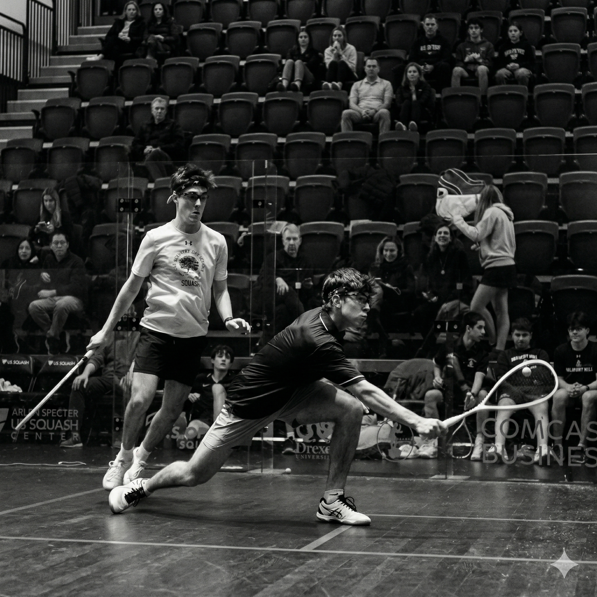 Two youth players rallying during a squash point